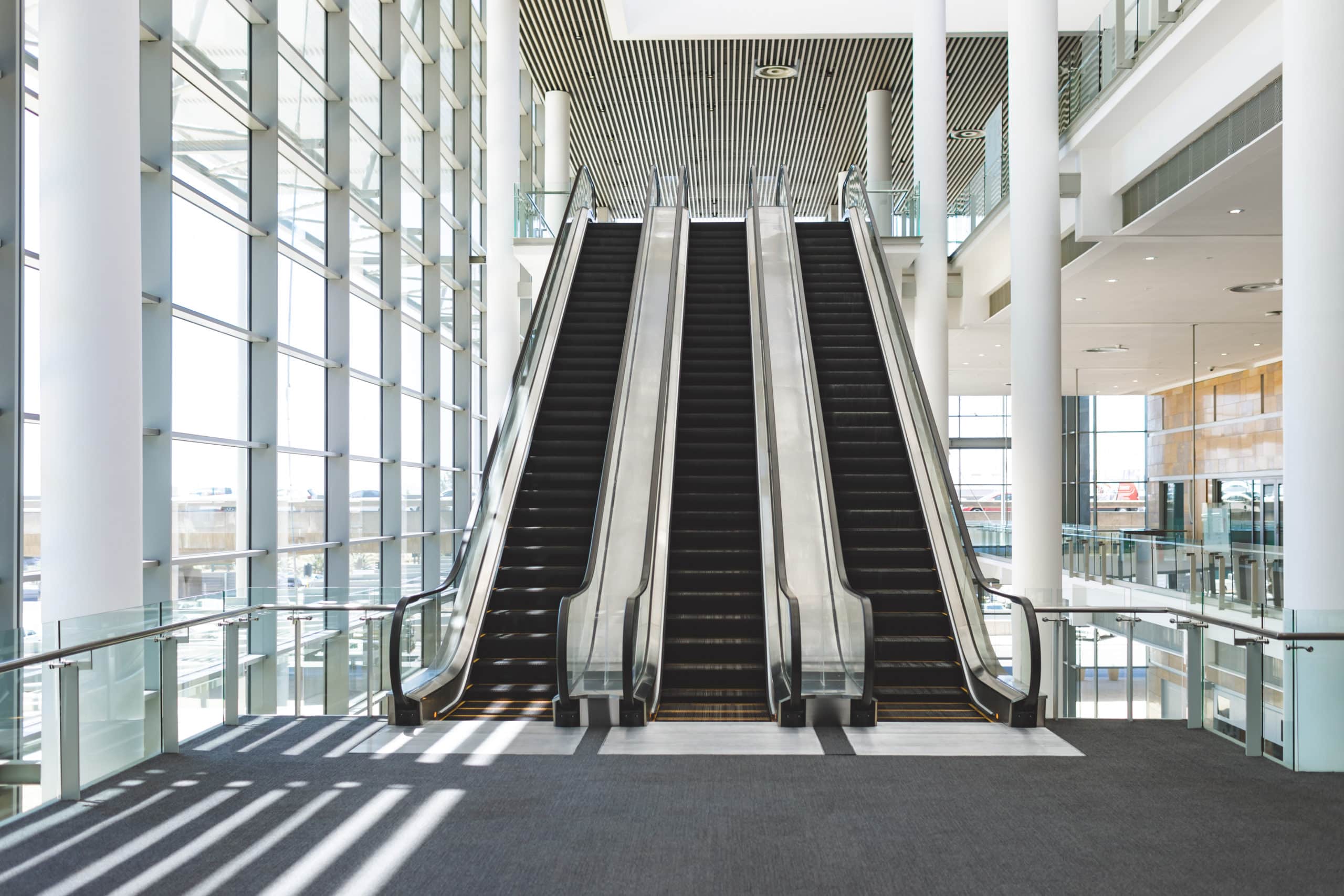 Front view of escalators in an empty modern office building